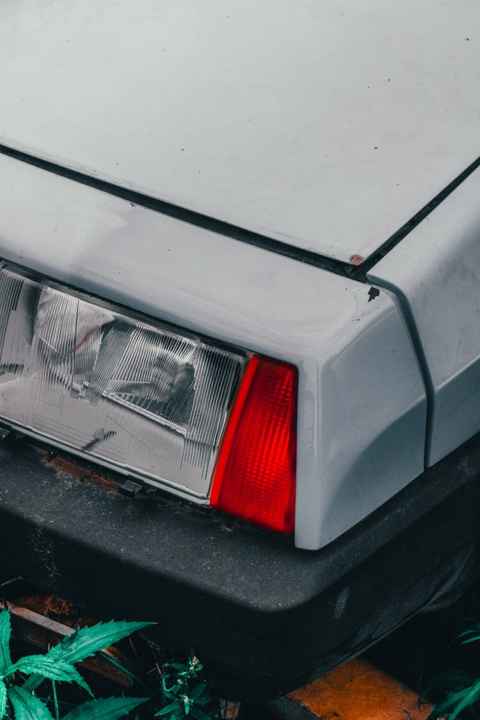 Detailed view of a vintage car's tail light and bodywork, emphasizing its classic design.